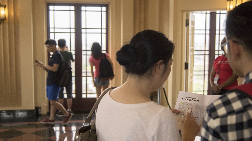 Two people looking at a Doors Open Toronto map
